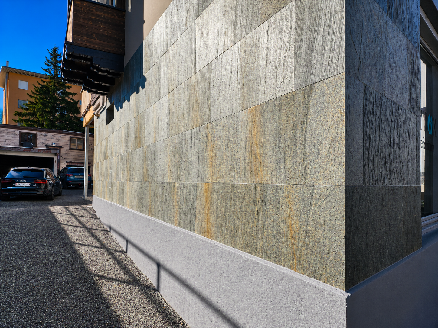 Modern home exterior featuring Skinrock West natural stone cladding with striking natural veining and a durable architectural finish.
